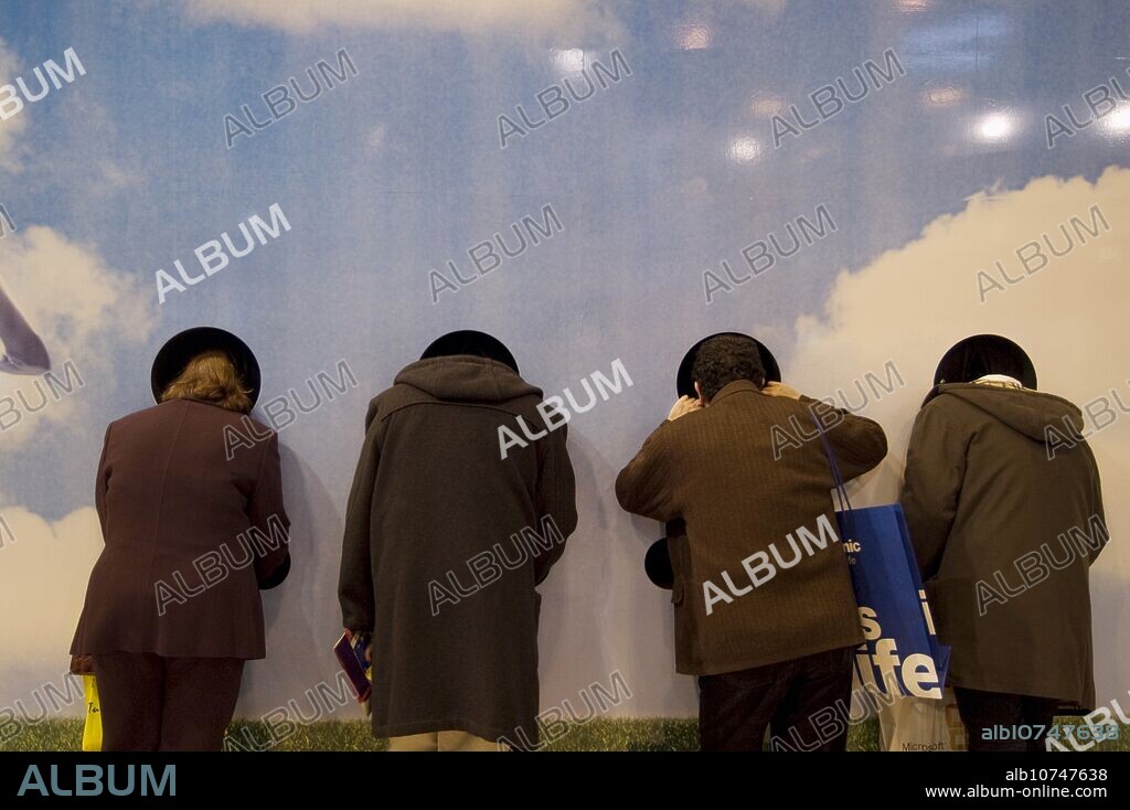 people looking through a hole, Cellular telephony stand, SIMO TCI, International Computing, Multimedia and Communications Expo. IFEMA. Madrid. Spain.