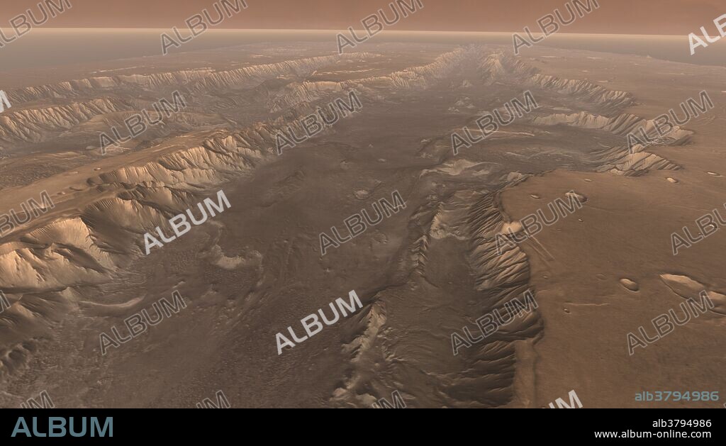 Soaring high above Valles Marineris, the "Grand Canyon of Mars," viewers look down and catch a sight resembling parts of the desert West of the United States, but on a vastly greater scale. Here the canyon averages over a hundred miles wide, and its floor is heaped with rocks, sediments, and landslide debris. Within the canyon walls lie possibly hundreds of layers filling many pages of Mars'geologic record. This scene comes from "Flight Through Mariner Valley," an exciting video produced for NASA by the Jet Propulsion Laboratory. The video takes viewers on a simulated flight into Valles Marineris, where they explore its scenic wonders as their imaginary scout ship dives low over landslides and races through winding canyons. The video features high-resolution images from Arizona State University'sThermal Emission Imaging System multi-band camera on NASA'sMars Odyssey. The images, which show details as small as 300 meters (1,000 feet) across, were taken at infrared wavelengths during the Martian daytime. Scientists joined hundreds of individual frames from the camera into a giant mosaic, then colored the mosaic to approximate how Mars would appear to the human eye.To give the mosaic depth and height, moviemakers fitted it to a computerized topographic model for Valles Marineris. This was developed using hundreds of thousands of altitude measurements by the Mars Orbiter Laser Altimeter, an instrument on NASA's Mars Global Surveyor spacecraft.