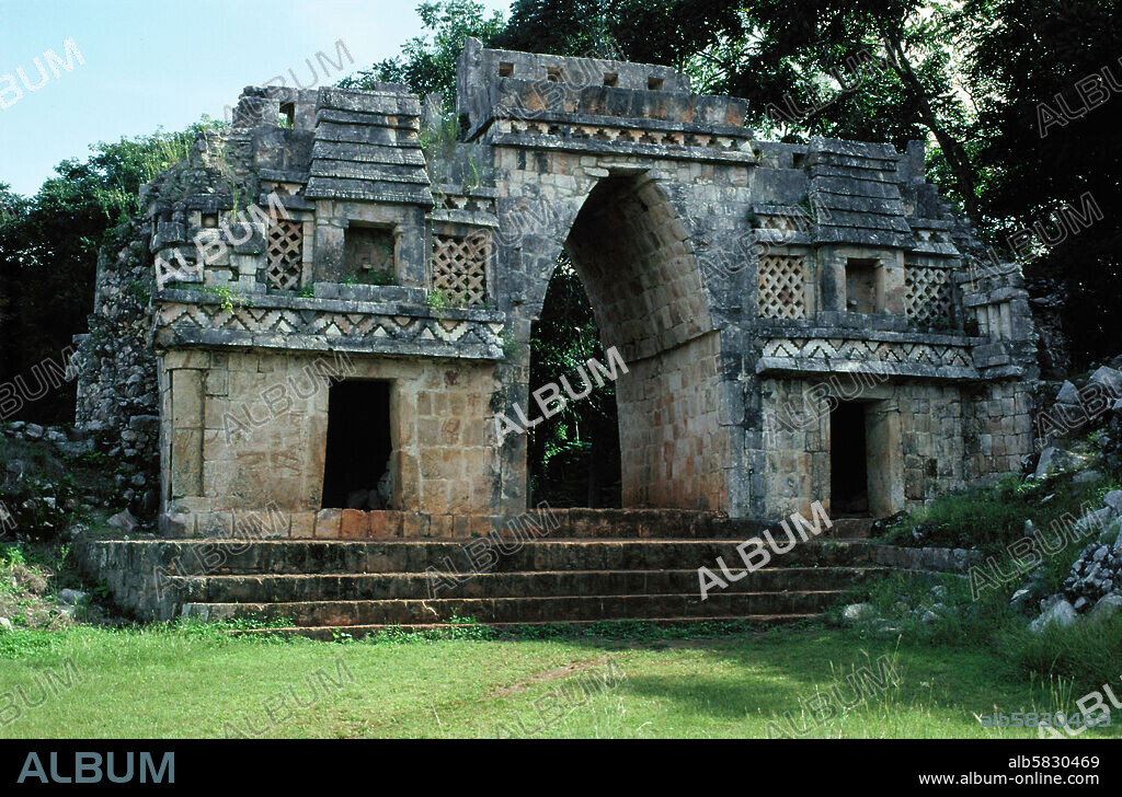 The monumental arch in Labna, Puuc, Archaeological Zone, Yucatan. The arch linked two residential areas of the Maya town of Labna; it is a typical triangular " false" arch flanked by two side doors and two orna-mental huts with niches for seated statues (7th-10th) .