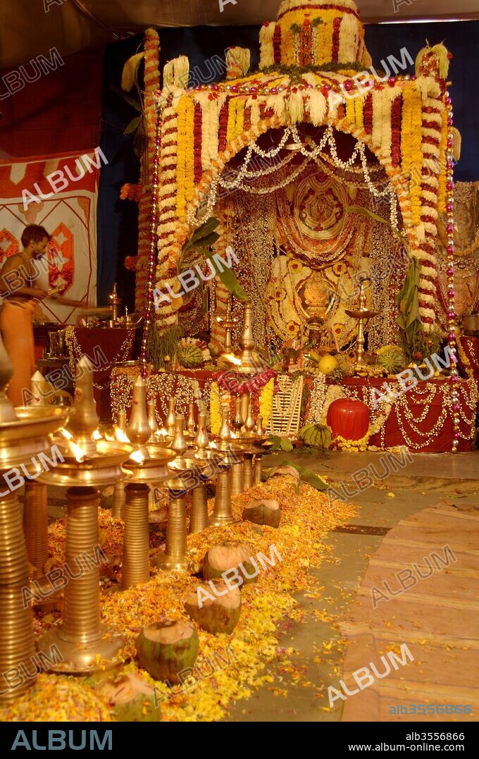 Flower decorations on floor and brass lamps at Ayyappa Pooja ; Kerala ; India.