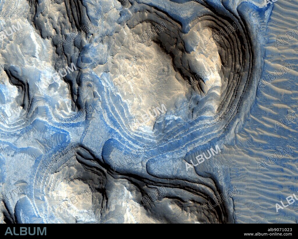 Geologic layering on Mars. image from the HiRISE high-resolution camera on board the Mars Reconnaissance Orbiter (MRO) shows multiple layers of exposed sedimentary rock on Mars in a region known as Arabia Terra. Referred to as cyclic bedding by geologists, this pattern of layering is caused by repeated fluctuations in the amount of sediment available to create new rock layers. This is often caused by long-term changes in the climate of a region, or even by wobbles in a planets rotation which can make certain areas experience long periods of dry climate followed by periods of wetter climate.