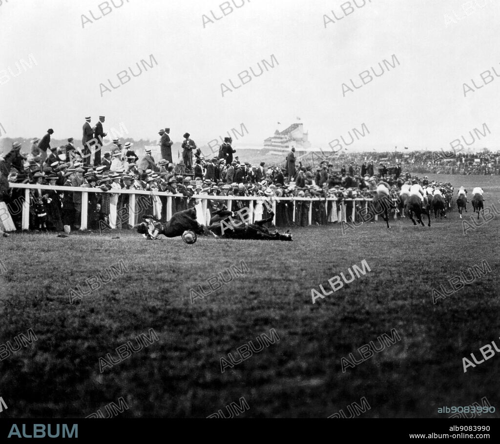 Votes for women, Suffragette Protest at 1913 Epsom Derby.. As the horses swept round Tattenham Corner little notice was taken of Emily Wilding Davison (1872-1913), in suffragette colours, who darted under the rails to clutch at the reins of the King's horse, causing it to fall and herself to die.. 9 June 1913.