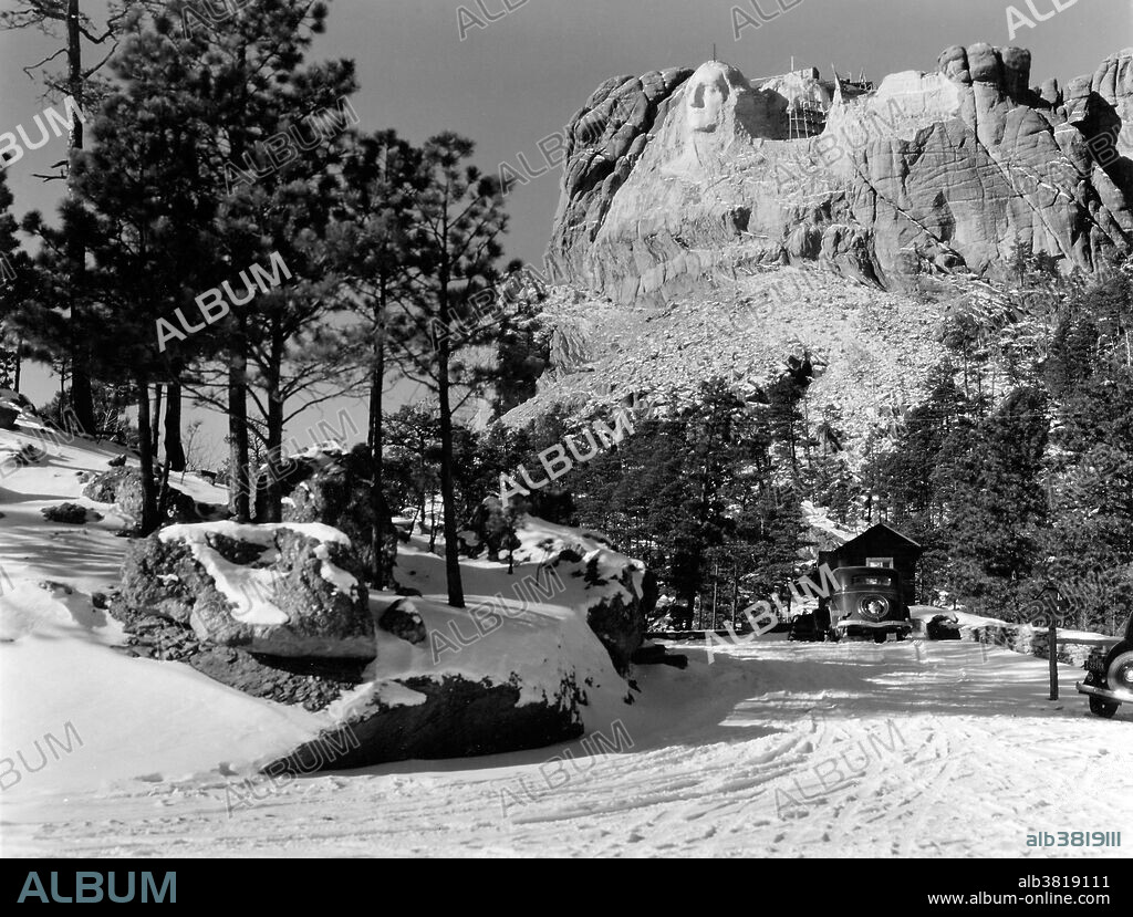 Mount Rushmore National Memorial is a sculpture carved into the granite face of Mount Rushmore near Keystone, South Dakota. Sculpted by Danish-American Gutzon Borglum and his son, Lincoln Borglum, Mount Rushmore features 60 foot sculptures of the heads of four United States presidents: George Washington, Thomas Jefferson, Theodore Roosevelt, and Abraham Lincoln. Construction on the memorial began in 1927, and the presidents' faces were completed between 1934 and 1939. Although the initial concept called for each president to be depicted from head to waist, lack of funding forced construction to end in late October 1941. Mount Rushmore has become an iconic symbol of the United States, and attracts over three million people annually. Photographed by Charles D'Emery, undated.