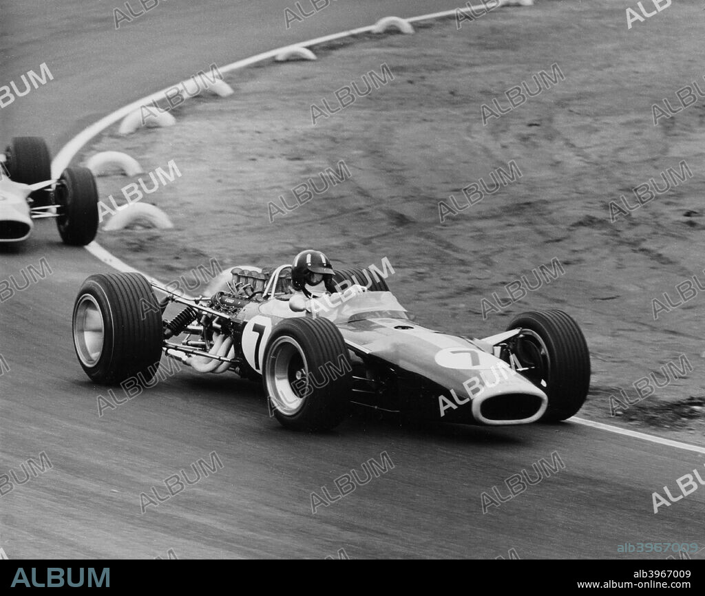 Graham Hill in a Lotus 49, French Grand Prix, Le Mans, 1967. Hill, driving a Lotus 49-DFV, leads teammate Jim Clark through one of the tyre-lined corners of the Bugatti circuit at Le Mans. Both cars retired early with final drive failure.