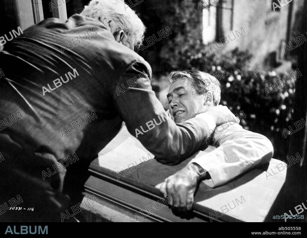 JAMES STEWART and RAYMOND BURR in REAR WINDOW, 1954, directed by ALFRED HITCHCOCK. Copyright PARAMOUNT PICTURES.
