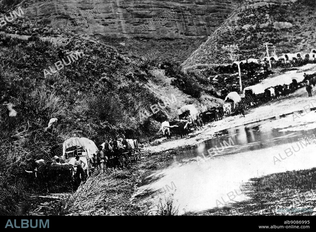 A Mormon emigrant train in Echo Canyon Utah , following the route of the telegraph poles to Salt Lake City in 1867.