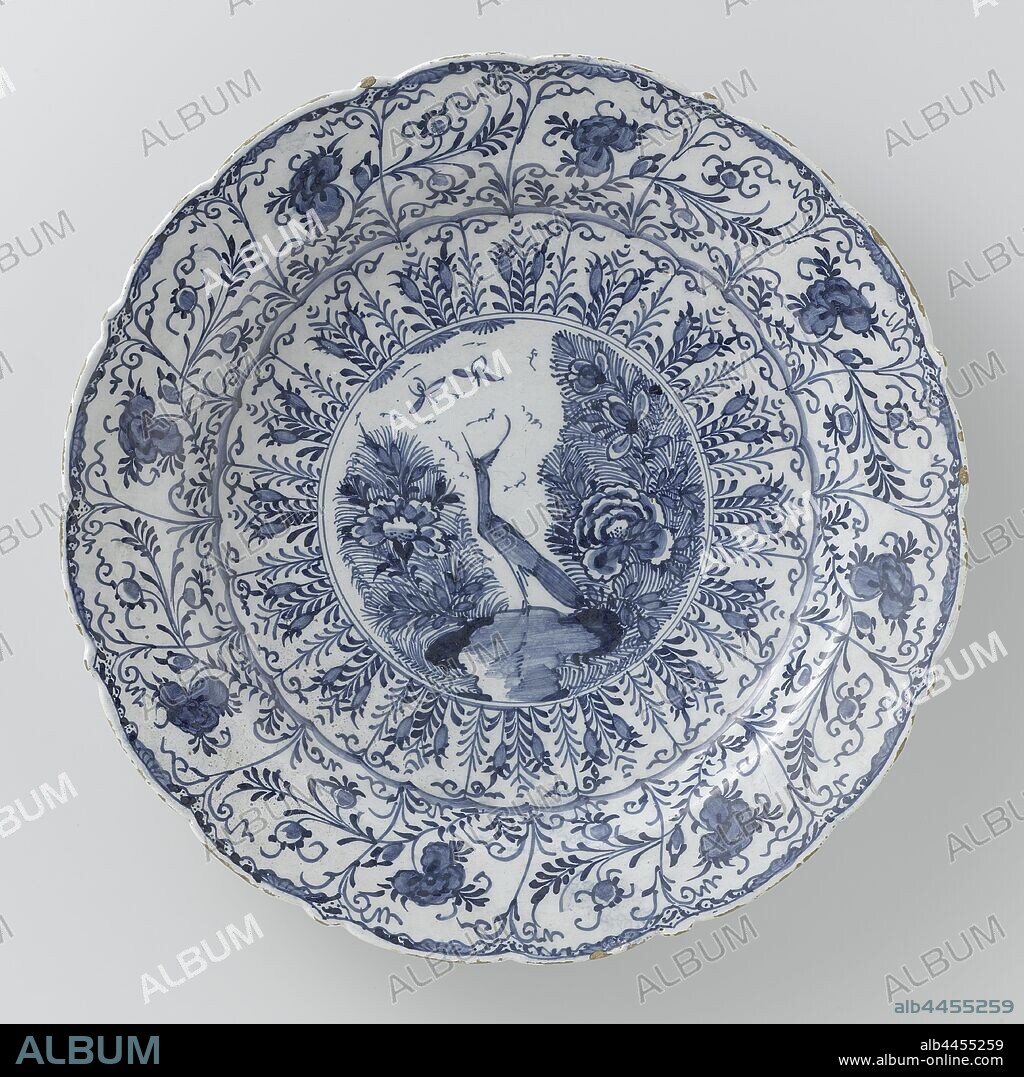 Dish, Round dish of blue painted faience, with a scalloped edge. A bird (heron?) Is painted on the shelf between flowers and on the edge flowers and leaves. The dish is marked: P and P. The dish was given on loan to the Historical Museum in Venlo in 1967, De Porceleyne Byl (mentioned on object), Amsterdam, c. 1750 - c. 1790, earthenware, tin glaze, d 35.0 cm × h 5 cm.
