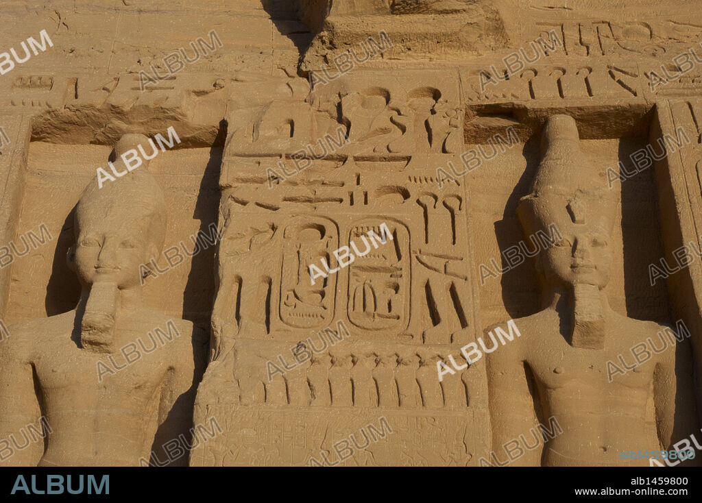 Egyptian art. Temple of Hathor or Small Temple dedicated to Nefertari. Facade depicting the pharaoh Ramses II (1290-1224 BC) with white crown of Upper Egypt and false beard (left) and with double crown and false beard (right). 19th dynasty. New Kingdom. Abu Simbel. Egypt.