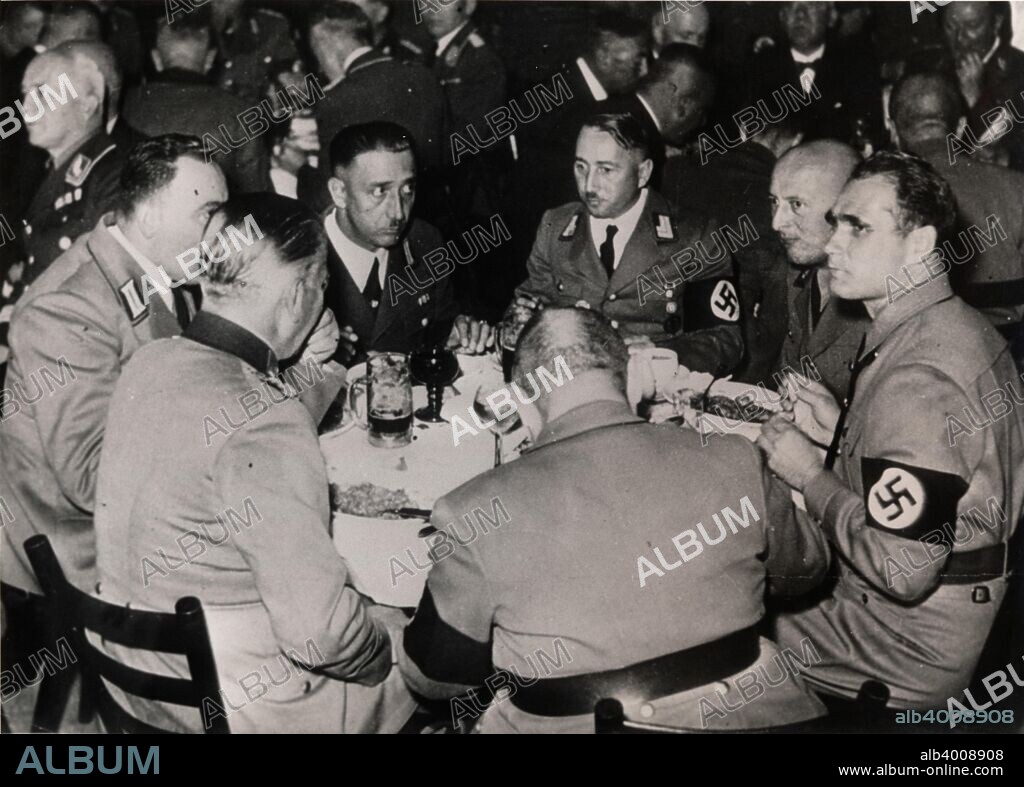 Nazi Deputy Leader Rudolf Hess with party colleagues, Bürgerbräukeller, Munich, October 1937. One of the main meeting places of the Nazi Party in its early days, the Bürgerbräukeller was the location from where Adolf Hitler launched the Beer Hall Putsch on 8 November 1923. After the Nazis came to power in 1933 they met there annually to commemorate the anniversary of the failed uprising.
