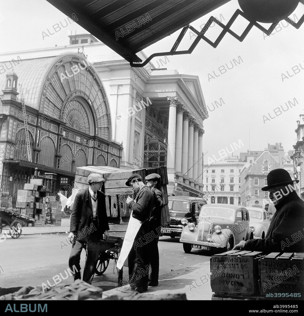 Covent Garden Market, London, c1952. Market traders stand outside the market by the Royal Opera House.