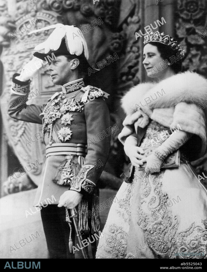 Royal Salute In Ottawa -- King George VI raises his hand in Royal, Salute on the steps of Parliament Building, Ottawa, May 19th. Standing beside the King, who is dressed in the full dress uniform of a Field Marshal of the British Army, is Queen Elizabeth, wearing a diamond tiara and a short cape of blue fox furs. May 20, 1939. (Photo by ACME).