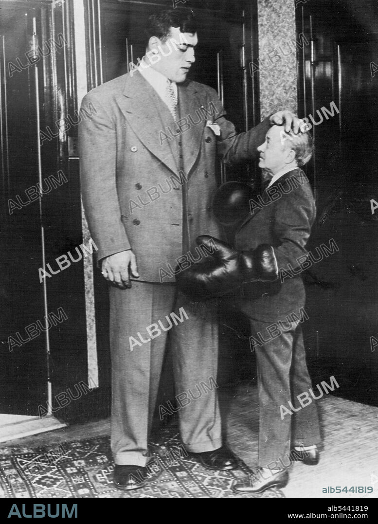 Tod Sloan Famous Jockey Seriously Ill - Tod Sloan with ***** Carnera, photographed during the boxer's visit to Los Angeles. Tod Sloan the famous jockey is reported to by dying of a liver ailment in a hospital at Los Angeles. Tod Sloan has been twice married and twice divorced. His last marriage followed a whirlwind courtship of the film actress. Betty Saxon. Sloan the most successful jockey of his time in England and America is now 59. Thirty years ago he revolutionised the style of race riding in England with his "crouch" seat. January 9, 1934.