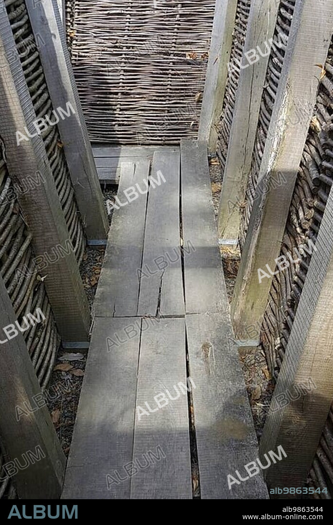 Reconstruction of German First World War One trench showing wooden duckboards and woven wickerwork branches at Zonnebeke, Belgium, Europe.