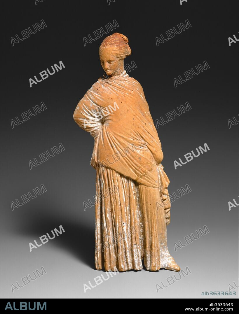 Terracotta statuette of a standing woman. Culture: Greek, probably Boeotian. Dimensions: H. 6 7/16 in. (16.4 cm). Date: late 4th-early 3rd century B.C..
Although the Greeks had been making terracotta statuettes since the eighth century B.C., it was not until the late fourth century that they began to produce the clay figurines that are still prized for their naturalness, variety, and charm.  These statuettes were first made in Athens and were soon being fabricated throughout the Mediterranean world, but they take their name from Tanagra, an ancient city in Boeotia, the region north of Attica, where great numbers were illicitly removed from tombs in the early 1870s.  Whereas almost all earlier terracotta figurines represented deities, the majority of Tanagras are fashionable women or girls elegantly wrapped in thin "himatia" (cloaks), often wearing large sun hats and holding wreaths or fans.  While most stand gracefully, some are seated or playing games.  A number of boys are represented and Aphrodite and Eros appear as well.  
Many of these figurines have been discovered in private dwellings.  Like other small-scale sculpture found in houses, they probably had a religious purpose and were placed in domestic shrines.  They were also dedicated in sanctuaries and put in tombs.  Up to a dozen statuettes were found in some graves at Tanagra.  Since fashionable ladies did not usually spend much time outdoors, religious festivals and funeral processions offered the best opportunities for displaying their finery.  It is therefore possible that for all their secular appearance, the Tanagras indirectly conveyed to the ancient viewer a reminder of serious ceremonies. 
Their relaxed curvaceous poses, sweet faces, and tightly wrapped drapery that forms a complex pattern of fine folds all derive from large-scale sculpture, such as the statues of Praxiteles, the famous Athenian sculptor who was active in the mid-fourth century B.C.  The intimate, secular spirit of the Tanagras also reflects contemporary comedies by Athenian playwrights such as Menander, which placed new emphasis on the foibles of everyday life.  The figurines still convey a sense of immediacy and liveliness that marks them as true works of art.