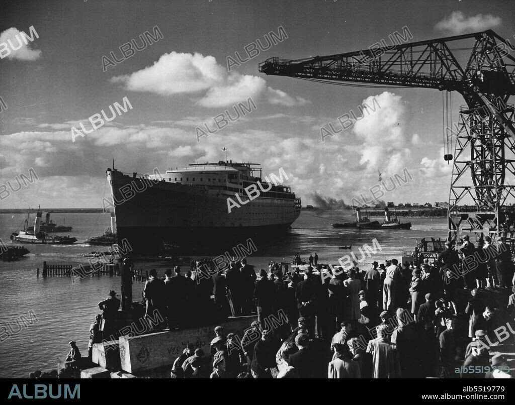 Largest Post-War Liner Launched -- The 31,000-ton liner "Orcades", built by Vickers-Armstrong for the Orient Line at their Barrow-in-Furness Yards, was launched yesterday by Lady Morshead, wife of the Sydney Manager of the Line. The "Orcades" is the biggest merchant ship in the world to be launched since the war, and has been built for the Australian trade at a cost of £3,000,000. It will carry over 1,500 passengers and 608 crew. The picture shows tugs fussing round the ship to take her out to the fitting out yards after the launch. October 15, 1947.