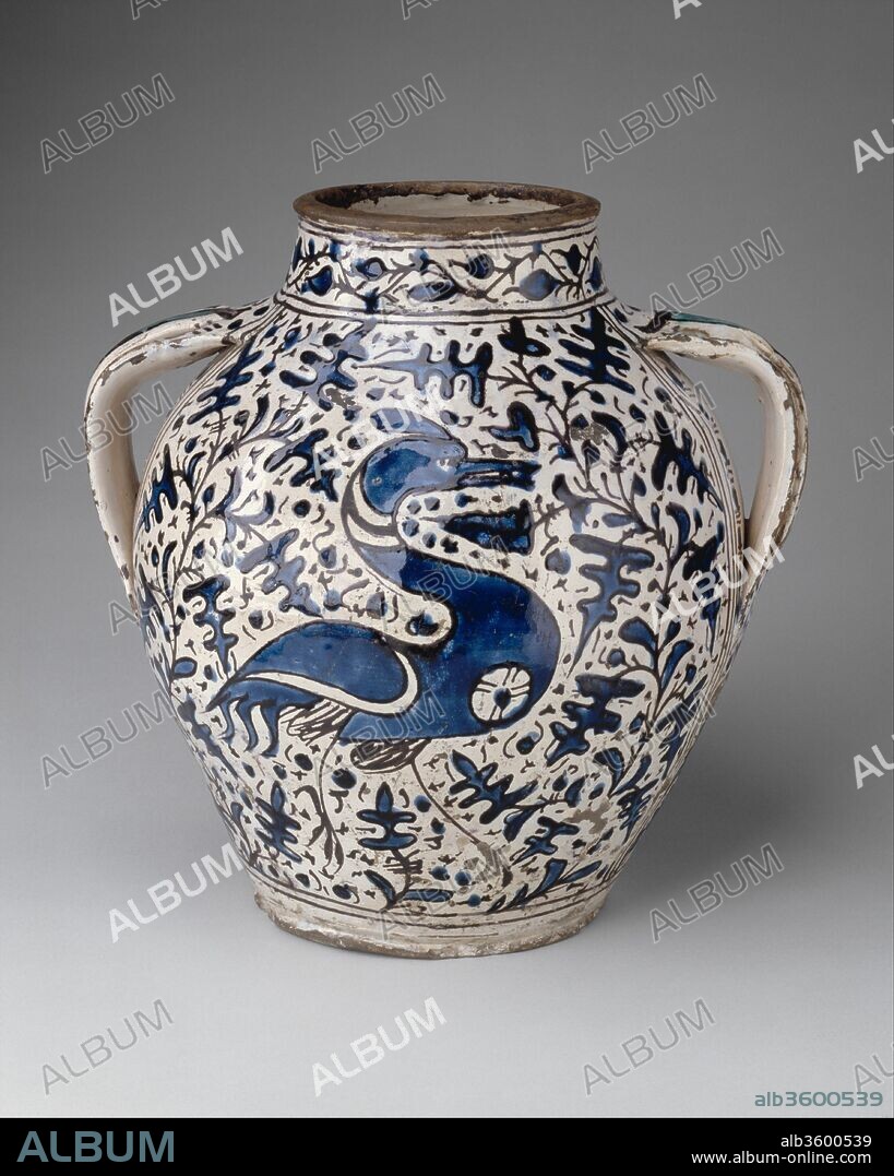 Apothecary jar (orciuolo). Artist: perhaps workshop of Giunta di Tugio (Italian (Florence), active ca. 1430-1466). Dimensions: H. 12 3/8 in. (31.5 cm). Date: probably 1431.
It is likely that this large and impressive apothecary jar, decorated with a crane against a ground of oak leaf foliage, belonged to the pharmacy of the Arcispedale Santa Maria Nuova, Florence's oldest and most distinguished hospital. Its likely maker, Giunta di Tugio, delivered many maiolica wares to the hospital, especially in the year 1431. The existence of other apothecary jars in the same style, also bearing the hospital's emblem, a crutch, suggests that they all form part of an extensive commission of maiolica wares executed by Giunta after Hispano-Moresque prototypes.