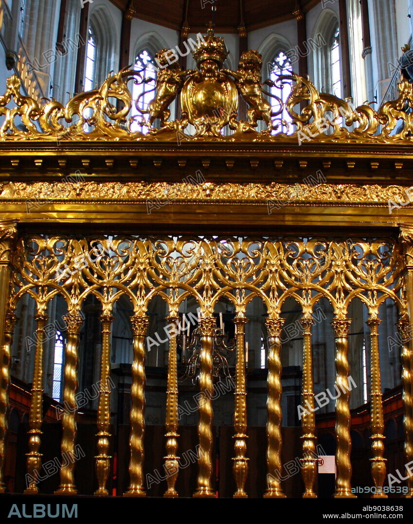 Gilded gate leading to the high altar at De Nieuwe Kerk, Amsterdam, Holland. The church was damaged by the city fires of 1421 and 1452 and burned down almost entirely in 1645, after which it was rebuilt in Gothic style. It underwent major renovation in 18921914, which added many neo-Gothic details, and was again renovated in 19591980.