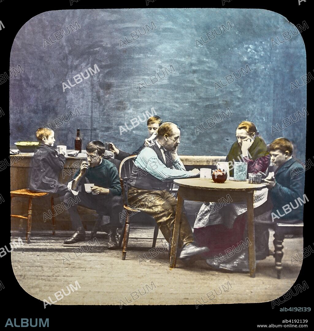 Magic lantern slide circa 1900.Victorian/Edwardian.Social History. Mrs Isabel Reaney story of Willie Wills Wings and slide show a christian story . Life model painted background. Slide 20 'How much longer are you going to have that youngster here?'. A family of porr children sitting around table with parents.