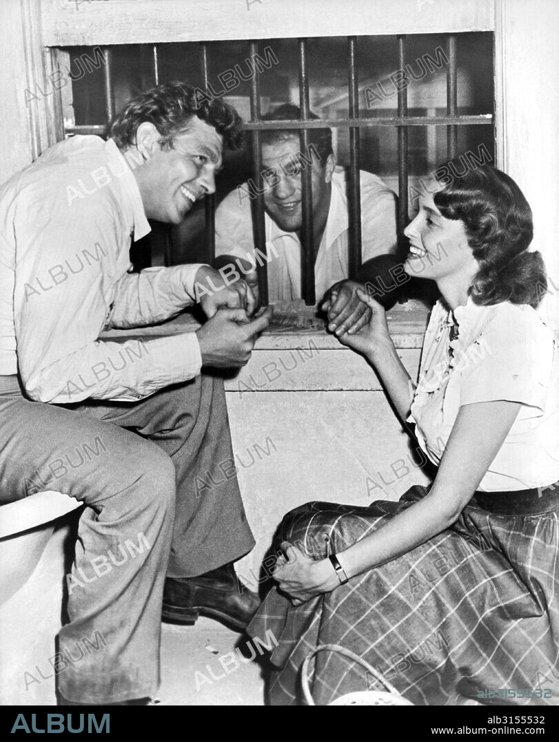 Hollywood, California:  1957. Retired heavyweight champion Rocky Marciano gets consoled on the set of 'A Face In The Crowd' by stars Andy Griffith and Patricia Neal. Marciano was visiting his friend Elia Kazan, director of the film.