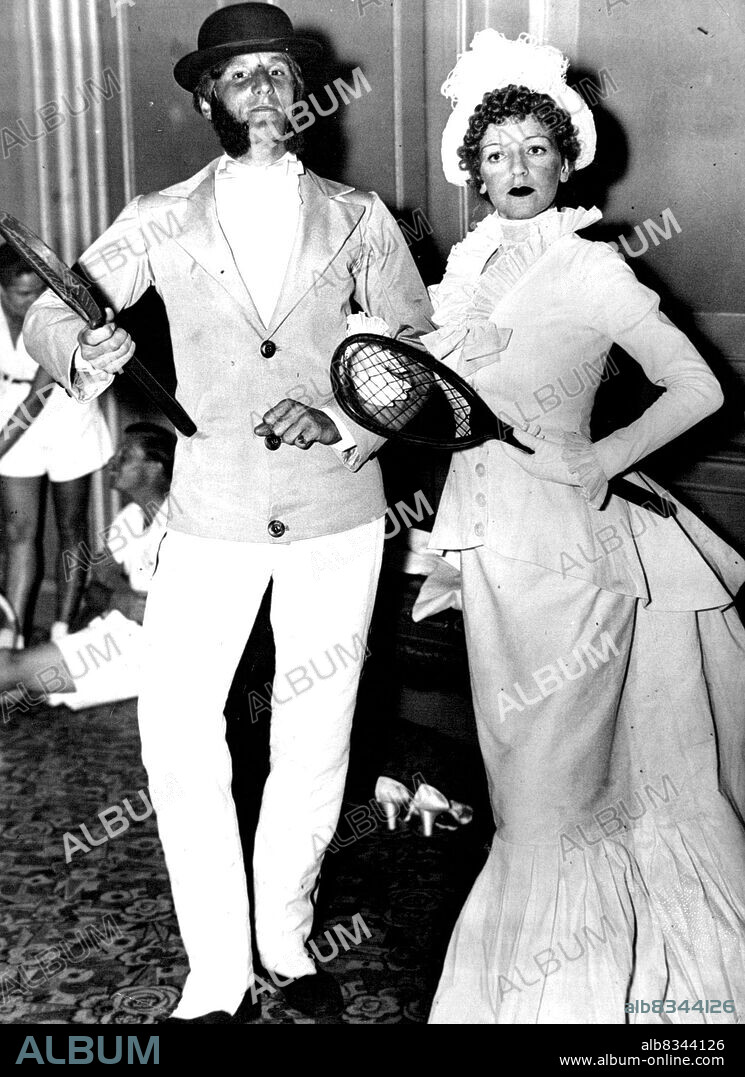 Some of our famous tennis players took part in an old-time costume ***** at Lady Wavertree's Tennis ball held at Grosvenor house, park Lane, London, July 9th.
How they were dressed in 1876. Fred Perry, the new tennis caption and Mrs. "Bunny" Austin (Miss Phyllis Konstam, the well known actress and film star) in the costumes they were in the Tennis Parade. August 13, 1934.