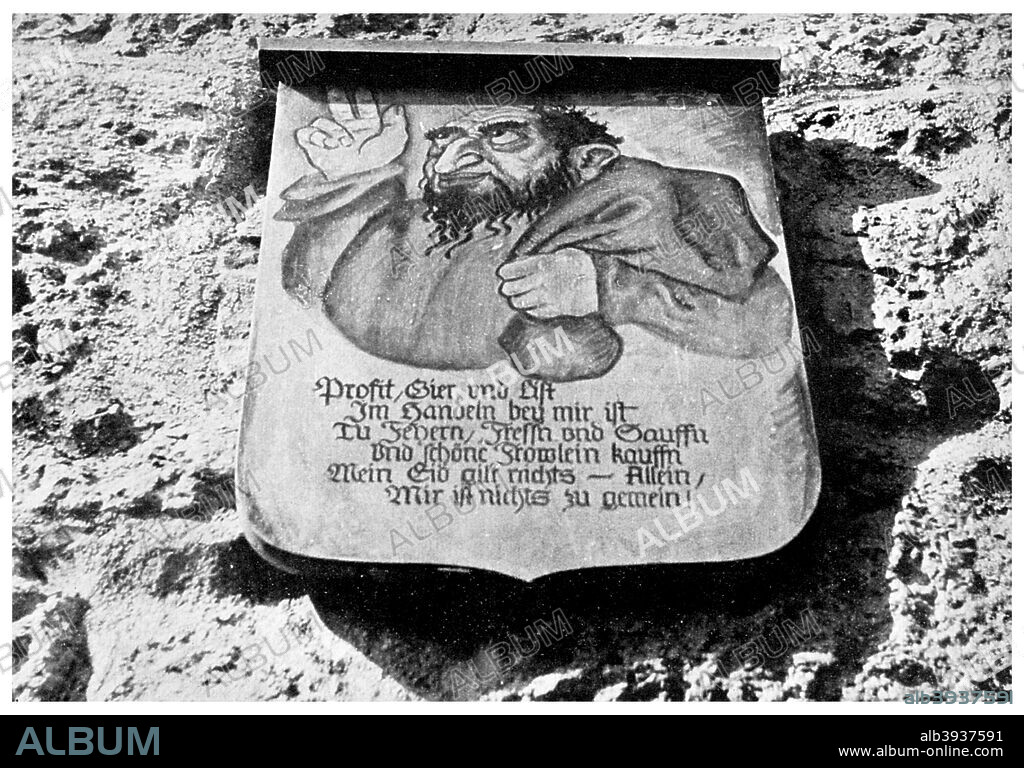Anti-semitism: medieval inscription on the town wall, Rothenburg, Germany, (1956). The placard shows a jew with a money bag. The text reads: Making big profits, greed and craftiness is my business. I like celebrating, eating and drinking and like buying nice girls. My oath does not mean a thing, in fact nothing is too low for me. A print from Ideas, a volume about the origin and early history of many things, common and less common, essential and inessential, by Readers Union, the Grosvenor Press, London, 1956.