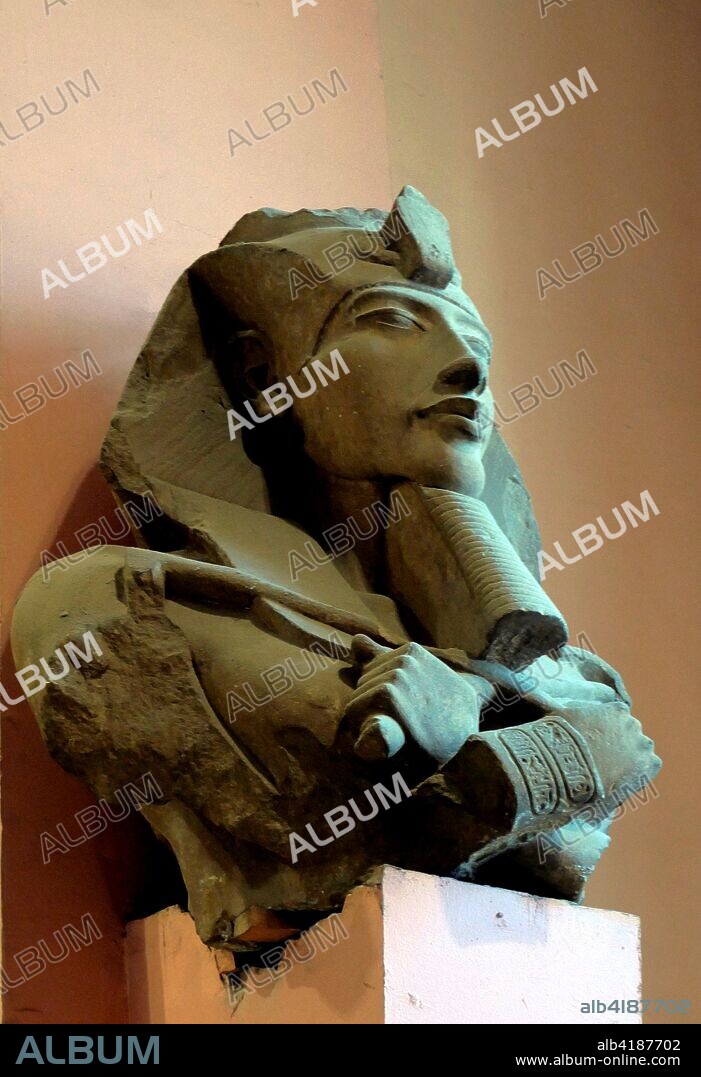 Bust of Akhenaten found in the Precinct of the Aten at Karnak. Sandstone. 18th Dynasty. Reign of Akhenaten (c. 1351-1334 BC). Part of a statue which was one of a series of colossi that once lined a colonnade in the Aten temple. erected by Akhenaten at the beginning of his reign at Kamal. He is wearing the nemes-headdress and holding the heqa sceptre and the flail.