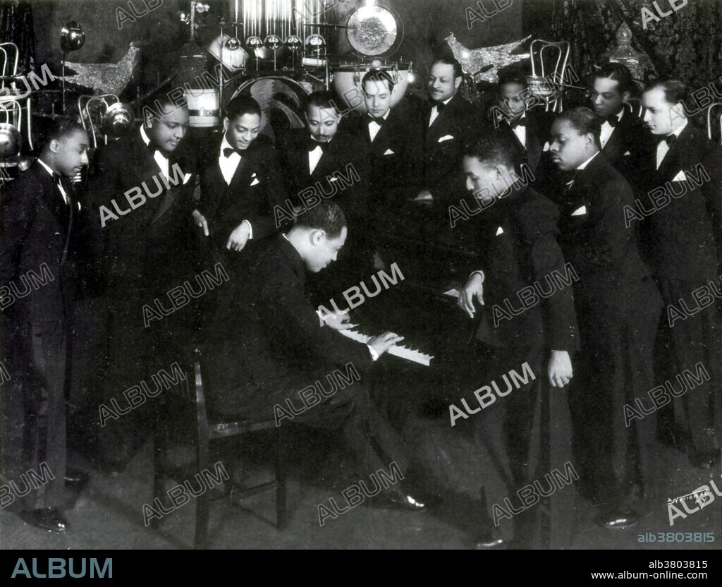 Ellington, center, playing piano (clockwise from left) Freddie Jenkins, trumpet; Cootie Williams, trumpet; Sonny Greer, drums; Arthur Whetsol, trumpet; Juan Tizol, trombone; Wellman Braud, double bass; Harry Carney, baritone saxophone; Freddy Guy, banjo and guitar; Barney Bigard, clarinet; Ticky Sam canton, trombone; and Johnny Hodges, alto saxophone, 1930s. Edward Kennedy Ellington (April 29, 1899 - May 24, 1974) was an American composer, pianist and bandleader. His career spanned over 50 years, leading his orchestra from 1923 until he died. Born in Washington, D.C., he was based in New York City from the 1920s, and gained a national profile through his orchestra's appearances at the Cotton Club. Often collaborating with others, he originated over a thousand compositions and his extensive oeuvre is the largest recorded personal jazz legacy, with many of his extant works having become standards. Following an appearance at the Newport Jazz Festival in July 1956, he enjoyed a major career revival and, with his orchestra, embarked on world tours. He died from lung cancer and pneumonia in 1974, a month after his 75th birthday. His last words were, "Music is how I live, why I live and how I will be remembered." He was awarded a special Pulitzer Prize in 1999.