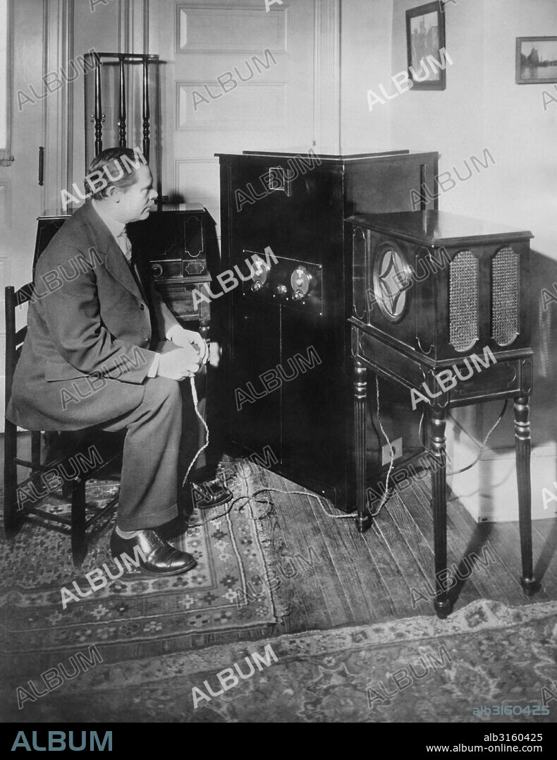Schenectady, New York: January 14, 1928 Dr. E.F. Alexanderson of GE and RCA and inventor of the radio television process where a listener can see as well as listen to the broadcast, operating his 3 inch screen home television set. This was the first home reception of television.