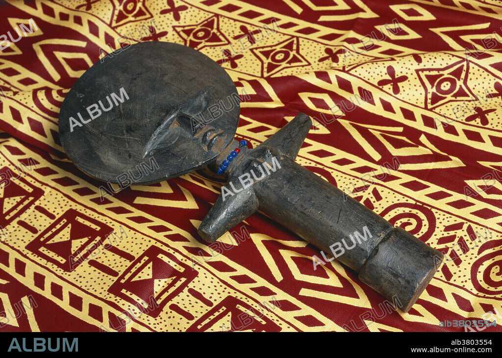 Wooden ritual fertility doll, known as Akuaba, from Ghana; on display at Wesleyan University in Ohio. This doll was made by the Ashanti people, whose dolls have large, disc-like heads. Other tribes in the region have their own distinctive style of Akuaba. Traditionally, these dolls are carried on the back of women either hoping to conceive a child, or to ensure the attractiveness of the child being carried.