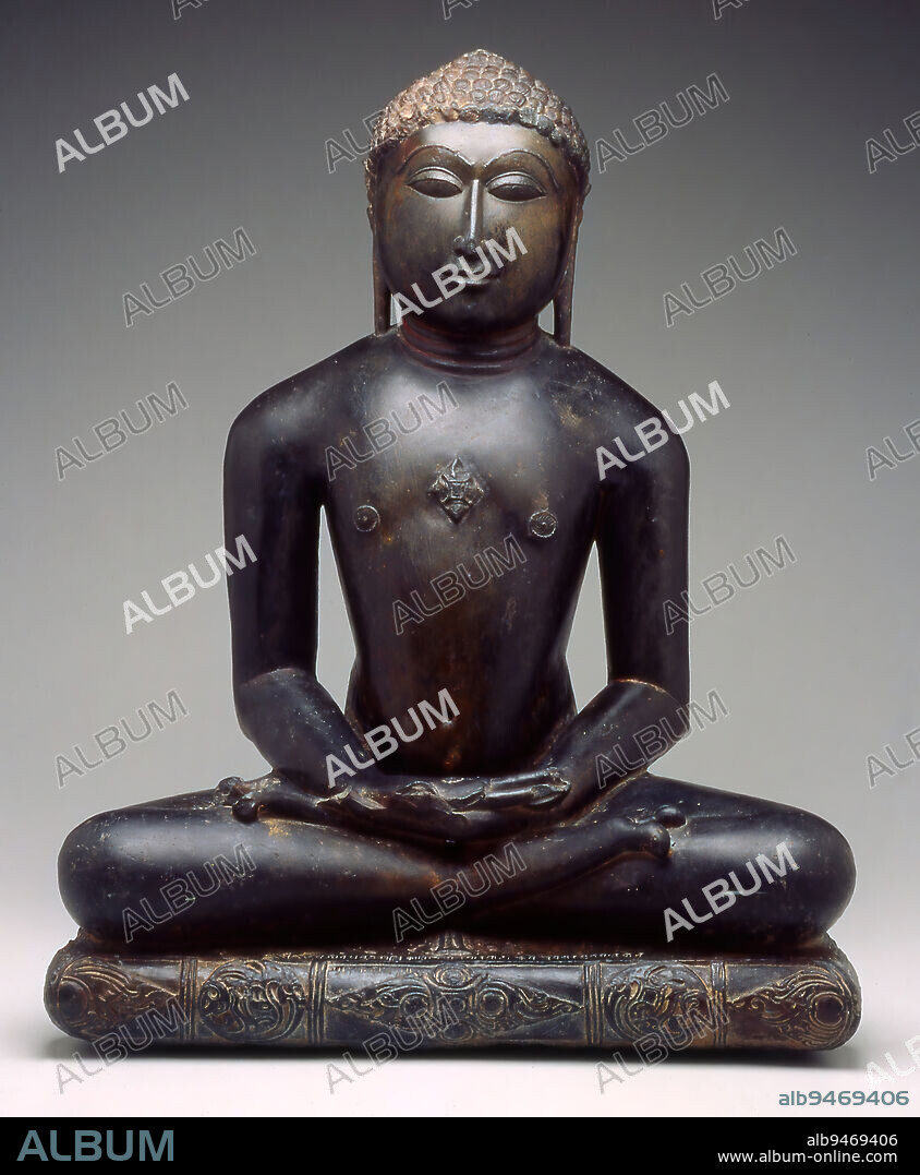 Seated Jina, c. 1108, 25 x 20 1/2 x 13in. (63.5 x 52.1 x 33cm), Black stone, India, 12th century, In Hinduism (Brahmanism), sculpture serves as a vessel for the divine spirit. In Jainism, sculptures like this one are inanimate and, instead, embody a model of behavior as perfected by the Jina. The Jina (perfected being) is a spiritual victor who has gained release from the world by abiding to strict principles of nonviolence and the abandonment of material possessions. Even physical or mental action is considered a form of material attachment. The Jina, of which there have only been 24 (the last being Jina Mahavira, founder of the Jain faith in the 500s bce), has arrived at the indestructible, immortal, and all-knowing inner soul. This ideal is expressed in the figures perfect stillness.