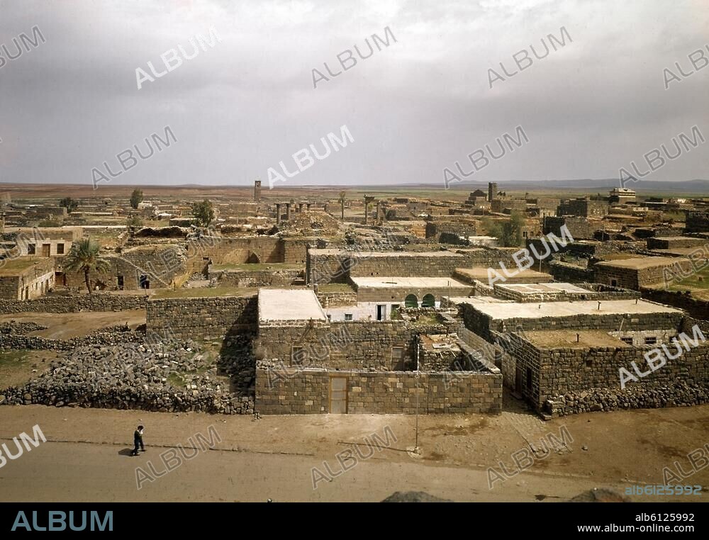 Bosra, also: Bostra, Busrana or Busra al-Sham (Daraa district, Syria), (capital of the  Nabatean empire and the Roman province  Arabia Petraea). View from the theatre across the town. Photo, undated.