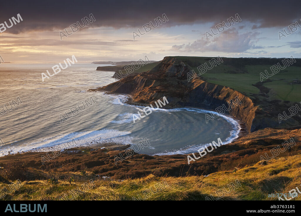 Storm light illuminates Chapmans Pool and Houns Tout cliff, viewed from St. Aldhelm's Head, Jurassic Coast, UNESCO World Heritage Site, Dorset, England, United Kingdom, Europe.