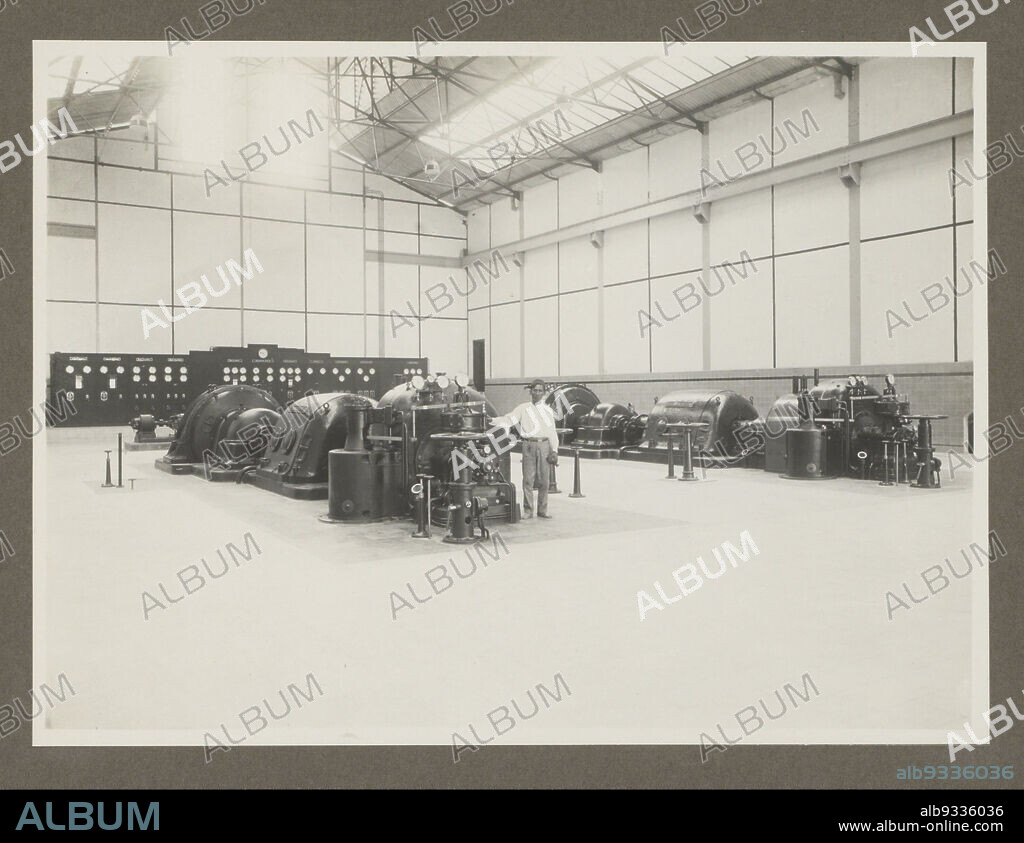 Goenoengsari (title on object), Turbine hall in the sugar factory of the HVA at Goenoengsari. Photograph in the photo album presented to A. van der Eyk on behalf of the chiefs and staff of the Handelsvereniging Amsterdam (HVA) in Surabaya on his departure from Java in April 1931., Atelier Kurkdjian, Surabaya, Apr-1931, photographic support, gelatin silver print, height 170 mm × width 230 mm.