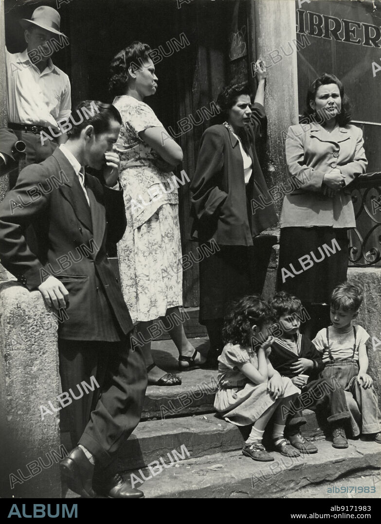 ROMULO LACHATANERE. Group of men, women and children gathered on stoop, East Harlem, New York City, 1947 - 1951.