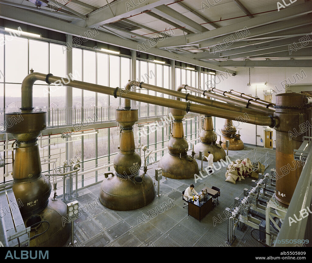 JOHN LAING PLC. Gordon's Gin distillery, Southfields, Laindon, Basildon, Essex, 09/01/1990. A view from the first floor of the recently completed distillery for Gordon's Gin, looking towards its five copper stills and two men working on the floor below.