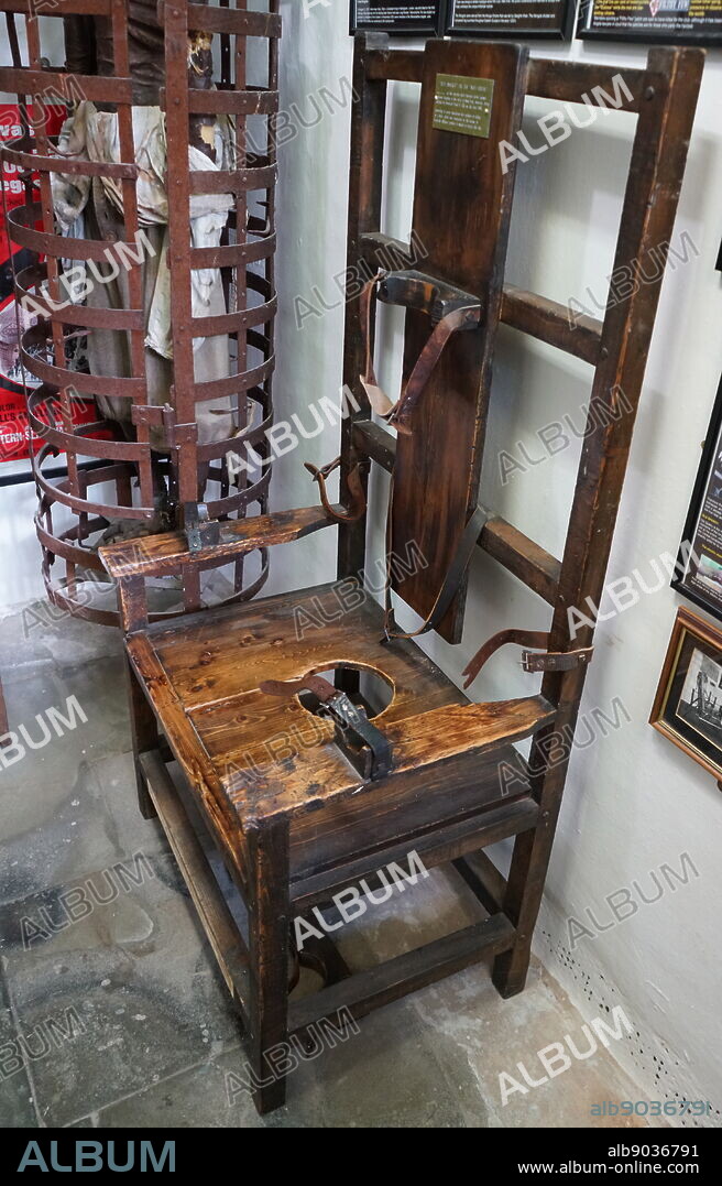 An electric chair known as "Old Smokey" or the "Mot Squat" . The electric chair is a method of execution originating in America in which the condemned person is strapped to a special wooden chair and electrocuted.