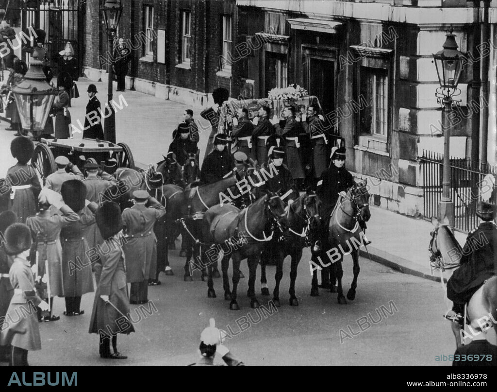 Queen Mary Leaves Marlborough House For Last Time -- The Coffin, covered with Queen Mary's personal standard, borne from Marlborough House (which was Queen Mary's residence) to the gun carriage by a bearer party from the Queen's Company, Grenadier Guards. Through streets lined with sorrowing crowds, Queen Mary made her last processional journey in London to-day (Sunday) when her coffin was taken from the Queen's Chapel, Marlborough House, to Westminster Hall for the lying--in-state. The Coffin was borne on a horse-drawn gun carriage of the King's Troop, Royal Horse Artillery. March 29, 1953. (Photo by Reuterphoto).