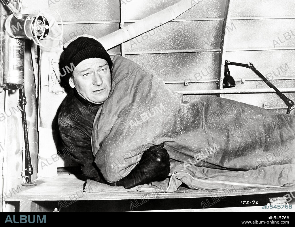 JOHN WAYNE in ISLAND IN THE SKY, 1953, directed by WILLIAM A. WELLMAN. Copyright WARNER BROTHERS.