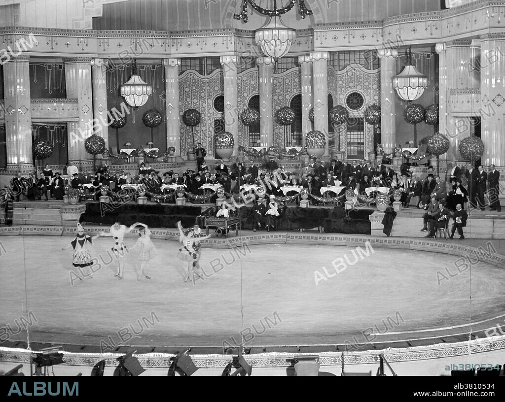 The Hippodrome Theatre was a theater in NYC from 1905-39, located on Sixth Avenue between West 43rd and West 44th Streets in the Theater District of Midtown Manhattan. It was called the world's largest theatre by its builders and had a seating capacity of 5,300, with a 100x200 foot stage. The theatre had state-of-the-art theatrical technology, including a rising glass water tank. The Hippodrome was built by Frederick Thompson and Elmer Dundy, creators of the Luna Park amusement park at Coney Island, with the backing of Harry S. Black's U.S. Realty, a dominant real estate and construction company of the time. The exterior of the red-brick and terra-cotta building was Moorish in style, with two corner towers, each of which was topped by a globe covered in electric lights. The Hippodrome's huge running costs made it a perennial financial failure, and a series of producers tried and failed to make money from the theatre. It was demolished in 1939. Photographed by Bain News Service, 1915-20.