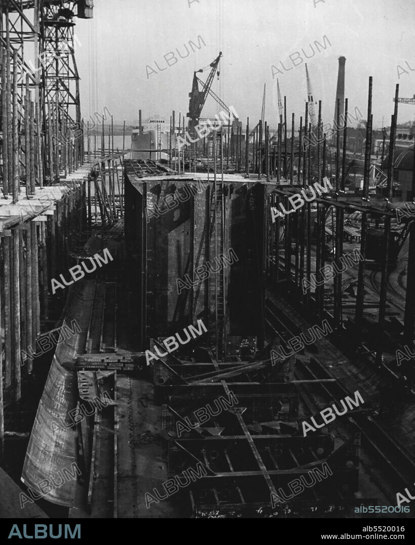 Tankers - An oil tanker under construction. The centre bulkheads are being erected on the button of the ship.Oil tankers are a highly specialized type of vessel and require a very high standard of workmanship. Longitudinal bulkheads run the full length of the cargo space and are crossed by transverse bulkheads, thus dividing the ship into a series of tanks. This system greatly strengthens the ship, and breaks up the movement of oil from side to side, which otherwise would cause dangerous instability in bad weather. September 13, 1951.