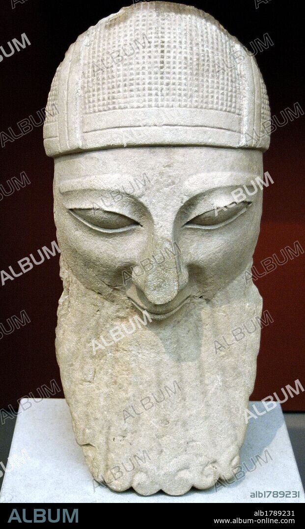 ARTE GRIEGO. CHIPRE. S. VI a. C. CABEZA de piedra caliza procedente de una estatua de un DEVOTO CON BARBA Y CASCO. Esculpida en Chipre entre 570-550 a. C. Procede de Biblos. Fenicia. Museo Británico. Londres. Inglaterra. Reino Unido.