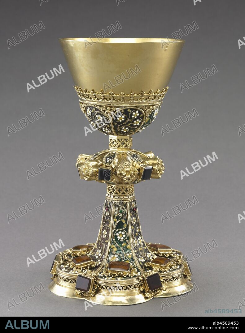 Chalice, c. 1450-1480. The chalice and paten?the most important liturgical vessels?are used at the altar by the priest for the consecration of the Eucharistic bread and wine during the celebration of the mass. This chalice survives with its original paten. The form of the chalice evolved over the centuries. Gothic chalices, like this one, gradually developed angular or faceted knops, generally hexagonal, with lobed feet. This sublime example is decorated with filigree enamel consisting of twisted gold wire forming a floral design, which in turn is filled with colourful glass pastes. Gemstones add to the embellishment.