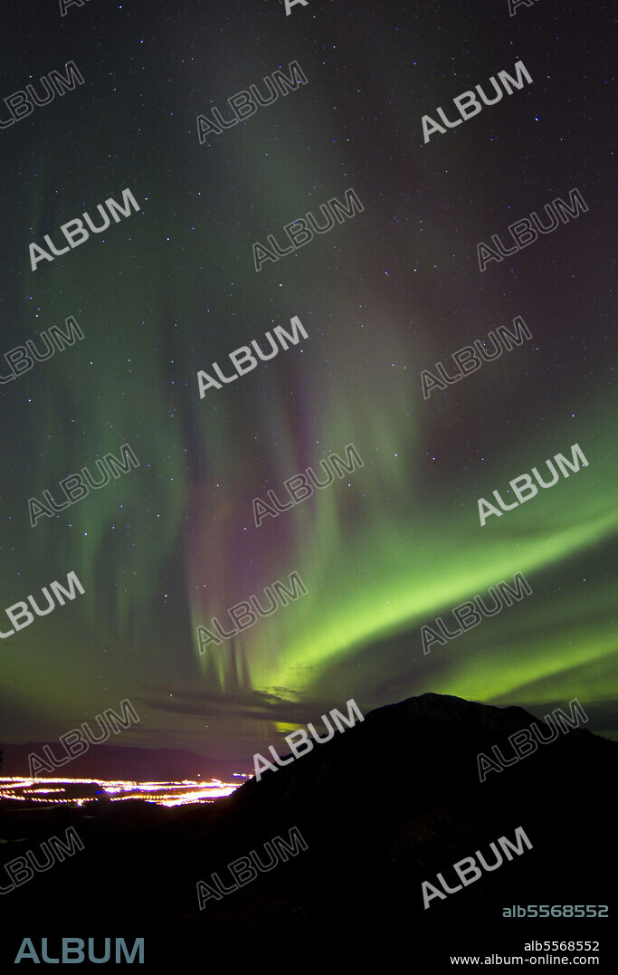 Aurora borealis over the city of Whitehorse, with Gray Mountain, Whitehorse, Yukon, Canada.