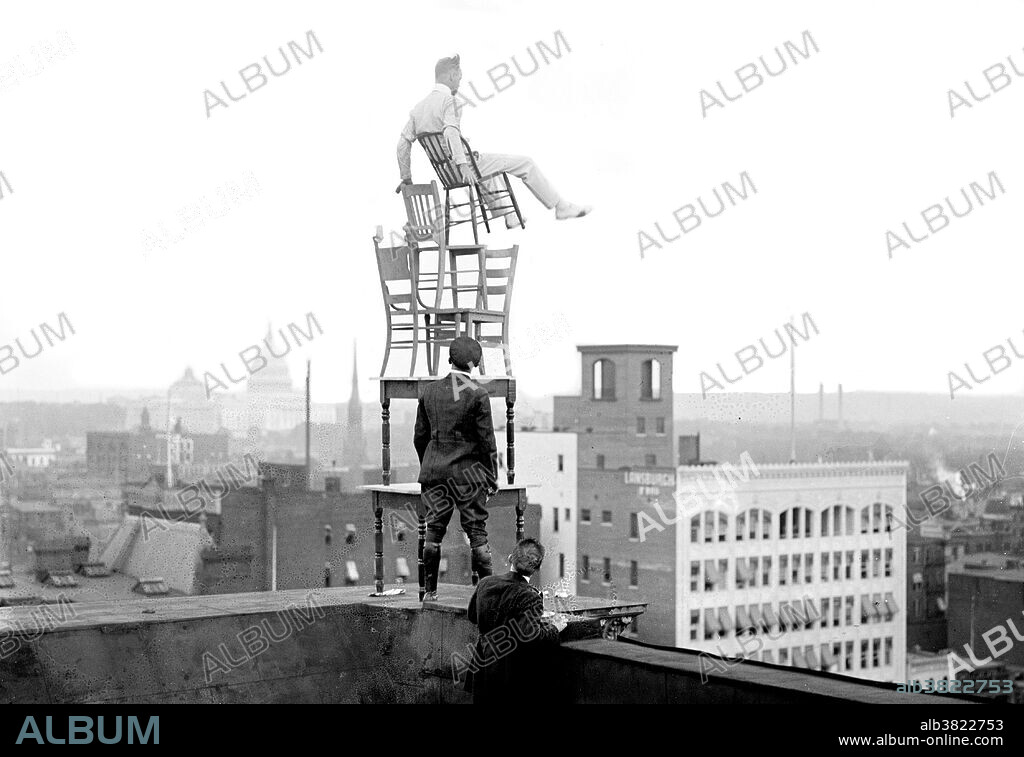 John "Jammie" Reynolds (born 1890 or 91 - ?) was an American daredevil. Little is known about early life, what became of him once he stopped performing or even his real name. An acrobat and juggler, he was known by many names - Daredevil Johnny, Daredevil Jack, the Climbing Wonder, The Lizard, the Human Spider, and the Human Fly. A newspaper article from 1922 claims he began performing at the age six in Buffalo, balancing on one foot from a flagpole 140 feet in the air. His first major stunt came at age 12 when he climbed up the side of the Old South Building in Boston, balancing atop four chairs and five tables on a plank projected over the side of the building. He gave similar performances in New York on its iconic Flatiron building, and at home in Philadelphia. Reynolds was arrested several times after his performances accused of "unlawful assembly". A stunt performer, often referred to as a stuntman, or daredevil, is someone who performs dangerous stunts, often as a career. Photographed by the National Photo Company, circa 1912-30.