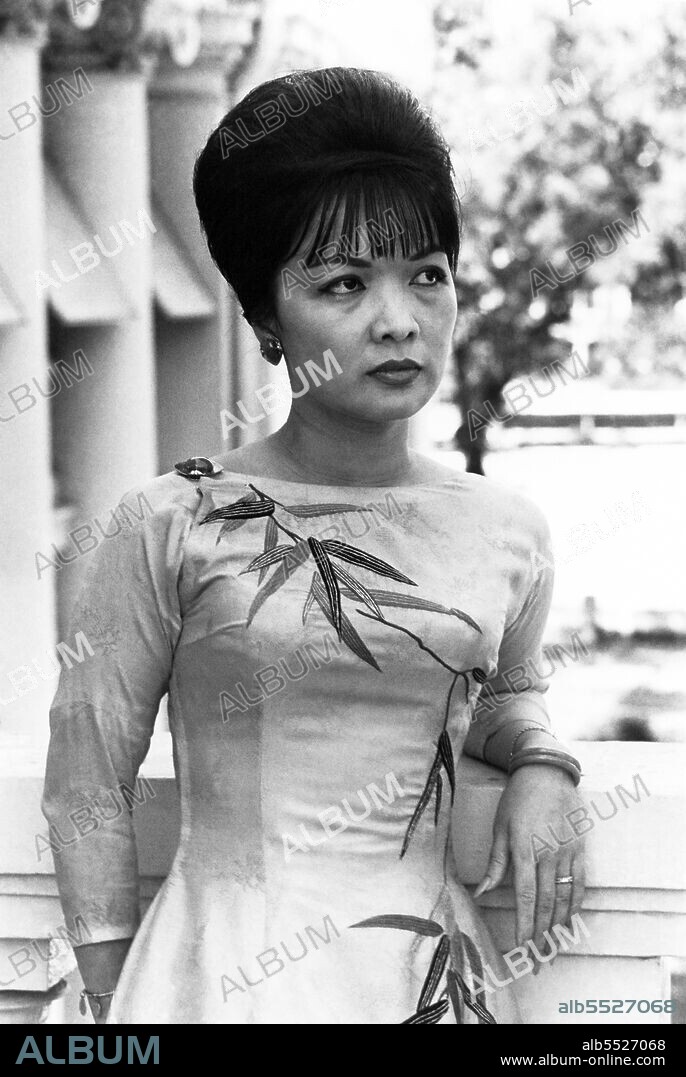Tran Le Xuan (born April 15, 1924 in Hanoi, Vietnam), popularly known as Madame Nhu but more properly Madame Ngo Dinh Nhu, was considered the First Lady of South Vietnam from 1955 to 1963. She was the wife of Ngo Dinh Nhu, brother and chief adviser to President Ngo Dinh Diem. As Diem was a lifelong bachelor, and because the Nhus lived in the Independence Palace, she was considered to be the First Lady. Diem often appointed relatives to high positions, so her father became the ambassador to the United States while her mother, a former beauty queen, was South Vietnam's observer at the United Nations. Two of her uncles were cabinet ministers. Madame Nhu was chauffeured in a black Mercedes and wore a small diamond crucifix. She also wore form-fitting apparel so tight that one French correspondent suggestively described her as, 'molded into her .. dress like a dagger in its sheath'. On formal occasions, she wore red satin pantaloons with three vertical pleats, which was the mark of the highest-ranking women of the imperial court in ancient Annam.  After the overthrow of the Diem government in 1963, Madame Nhu went into exile in France and died at Rome, Italy, in 2011.