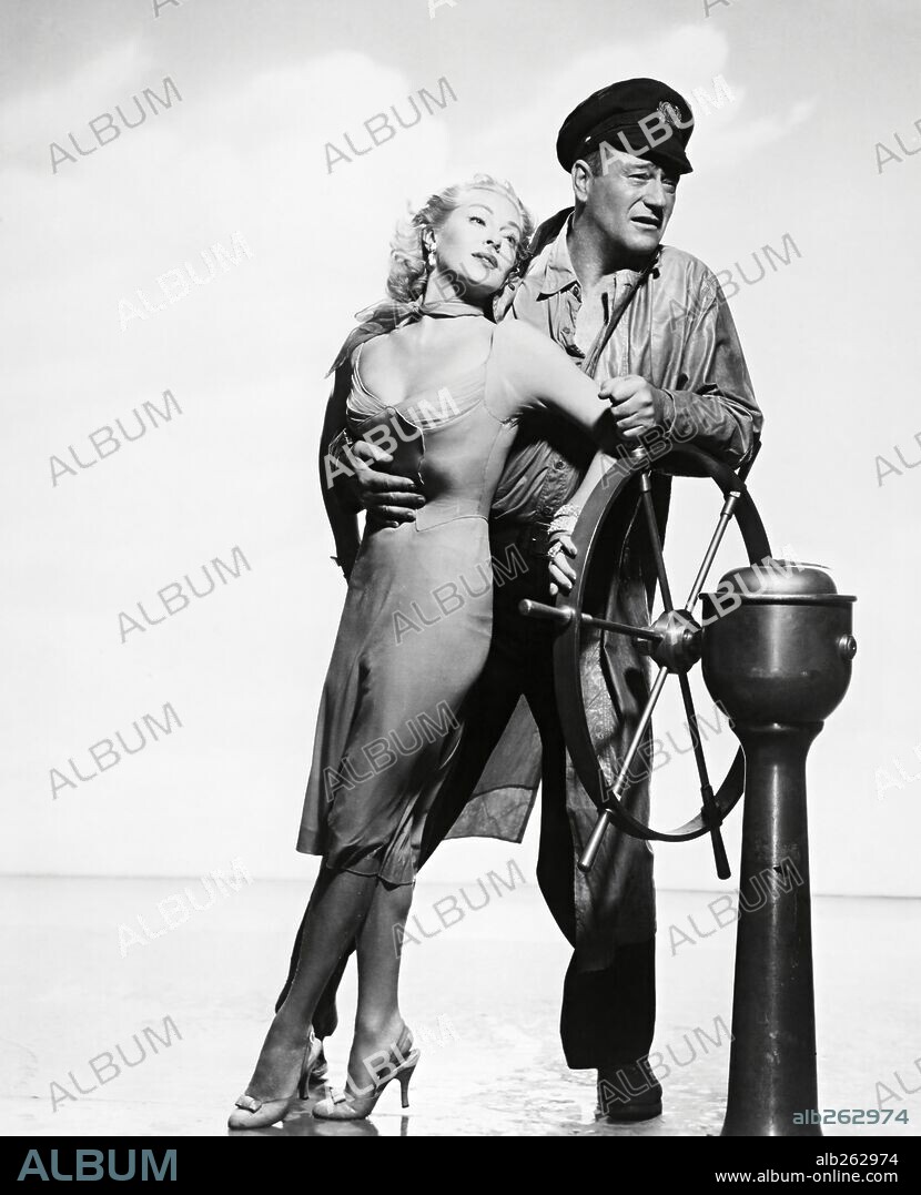 JOHN WAYNE and LANA TURNER in THE SEA CHASE, 1955, directed by JOHN FARROW. Copyright WARNER BROTHERS.