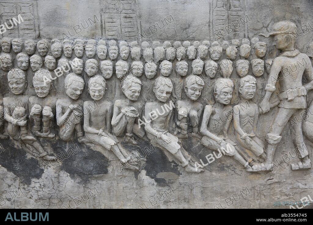 Memorial shrine festooned with bas-reliefs of Khmer Rouge atrocities at Wat Somrong Knong. Cambodia.