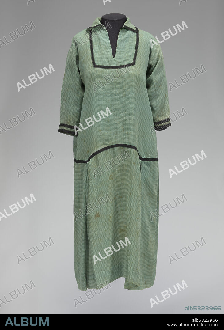 This dress belonged to Marie Monroe, a young woman who lived in Rosewood, Florida, during the 1923 Rosewood Massacre, a racially motivated massacre of black people and destruction of a black town in Florida, USA. At least six black people and two white people were killed, though eyewitness accounts suggested a higher death toll of 27 to 150. A green and cream checked A-line dress with black trimmings worn by Marie Monroe. The dress has a split-front neckline with a folded collar and straight-cut fitted sleeves that end below the elbow. The body of the dress is blousy and has a drop waist and pleated skirt with the hem falling mid-calf. The dress is made from a semi-sheer light green fabric with darker green and cream woven checks. Black woven tape is sewn in a rectangle around the split-neck, on the edges of the collar, in double lines on the cuffs of each sleeve, and around the drop waistline. The waist is scalloped, with two bottom points on the front and back at each side. The skirt has a box pleat extending from each of these points. The dress has no closure method, it slips on over the wearer's head. It is not lined.