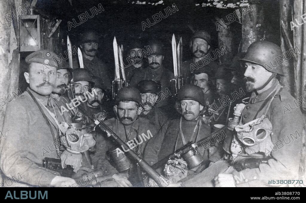 German troops endure a British bombardment on a dugout. Fully armed they are ready to rush back to the front line once the artillery barrage ceases. Dugouts were used extensively as protection from shelling during WWI in the Western Front. They were an important part of the trench warfare as they were used as an area to rest and carry out other activities such as eating. They would usually range in size from dugouts that could hold several men to dugouts that could hold thousands of soldiers. They were lined with concrete, wood and/or steel to withstand the shock of artillery, accessed via a set of wooden stairs. No date or location available.