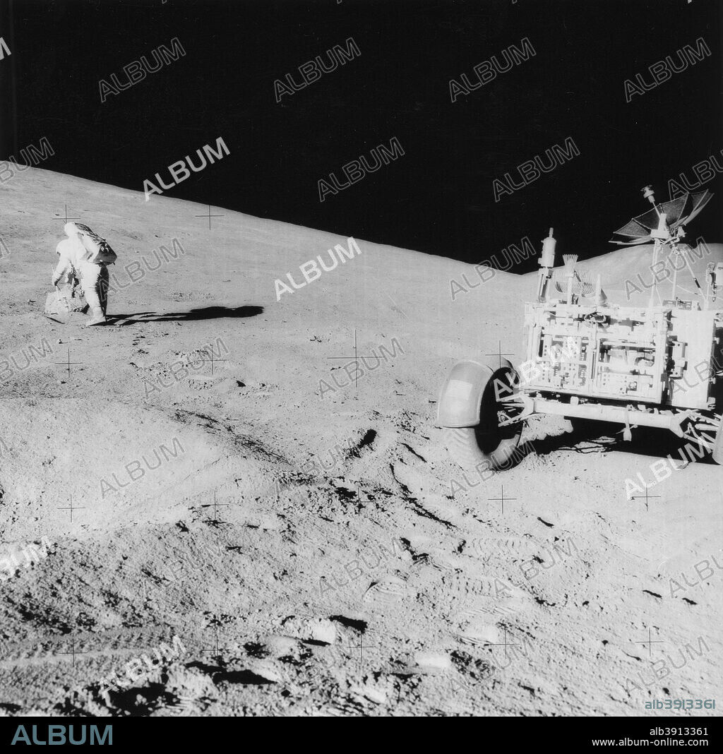 Astronaut David Scott (b1932) on the slope of Hadley Delta during Apollo 15, 1971. David Scott, mission commander, with tongs and gnomon in hand, studies a boulder on the slope of Hadley Delta during the Apollo 15 lunar surface extravehicular activity. The view is looking slightly southwest and Bennett Hill can be seen on the extreme right. The photograph was taken by fellow astronaut James B Irwin, pilot of the Lunar M.